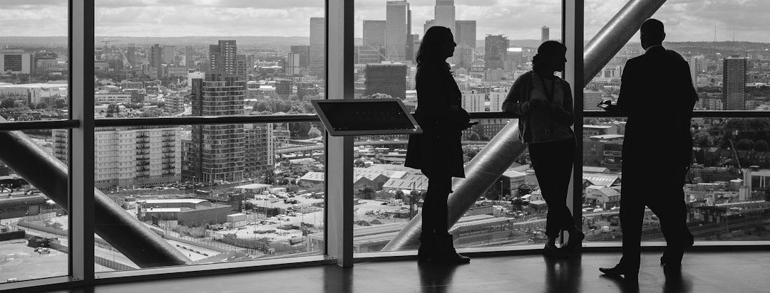 SourceArc Semi leaders discussing resilient semiconductor supply chain consulting, city skyline in background.